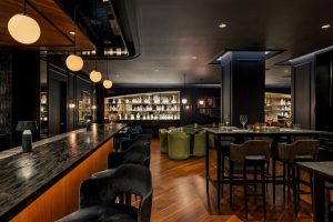The Anndore House, part of JVD by Hyatt, a gay-friendly hotel. Interior view of the bar and dining area with stylish decor.