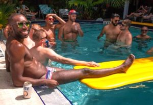 Key West Gay Cruise Clubs: Men enjoying a pool party. Some are in the water, others lounging on floats. Fun times at a gay Key West resort.