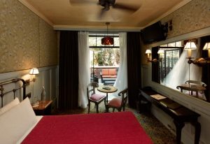 The Jane Hotel, New York: Interior view of a room. The most-booked gay-friendly hotel features a bed, table, and a terrace with seating.