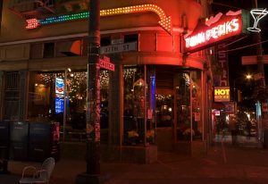 Twin Peaks Tavern in San Francisco's Castro District. Neon signs glow above the gay bar at night. 17th St & Castro St. Gay travel.