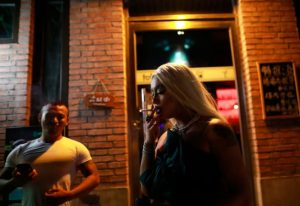 Nightlife at Jujiao Yanyi Bar. Drag queen smoking outside a gay bar. Gay travel advice. 700X480-1.jpg. Gay scene.