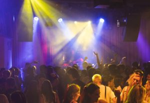 Beresford Hotel Sydney: Crowd dancing under stage lights. Popular gay bar in Surry Hills, Sydney. Gay travel advice.