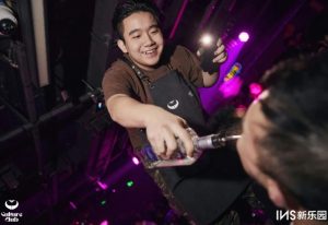 Culture Club: Bartender pouring a drink directly into a patron's mouth at the gay bar. Nightlife scene, fun atmosphere, travel advice.