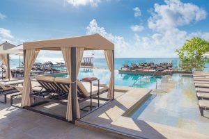Grand Hyatt Playa Del Carmen Resort gay-friendly hotel pool view. Cabana, lounge chairs, and ocean views. Ideal for gay travel in Playa del Carmen.