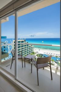 Hard Rock Hotel Cancun all-inclusive balcony view. Gay-friendly hotel room overlooking beach, ocean, and pool. Perfect for gay travel.