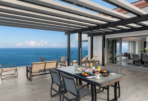 Hilton Vallarta Riviera All-Inclusive Resort terrace view. Gay-friendly hotel with outdoor dining, ocean view, and modern design. Perfect for travel.
