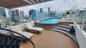 Rooftop pool and lounge area at Hotel Century Reforma, a gay-friendly hotel in Mexico City. City skyline view. Perfect for gay travel.