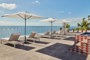 Hotel Luxury Patio Azul: Gay-friendly hotel patio with lounge chairs, umbrellas, ocean view. A relaxing space for gay travelers.