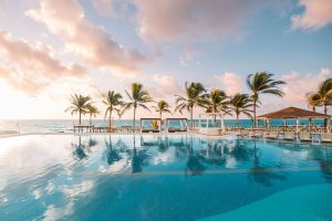 Hyatt Zilara Cancun pool view with palm trees. Gay-friendly hotel in Cancun, Mexico, offers a luxurious and relaxing vacation for gay men.