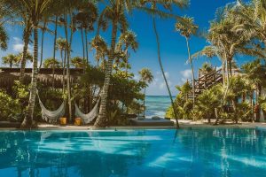 Jashita Hotel pool view. Gay-friendly hotel with hammocks, palm trees, and ocean access. A tropical paradise for gay men's travel.