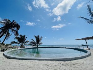 Maya Tulum By G Hotels: Round pool at this gay-friendly hotel. Beachfront view with palm trees. Ideal for gay men's travel.