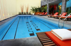 Mexico City Marriott Reforma Hotel pool. Gay-friendly hotel with lounge chairs. Indoor pool with black pattern. Great for gay travel.