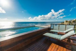 O' Tulum Boutique Hotel adults-only rooftop pool and sunbeds overlooking the beach. Gay-friendly hotel in Tulum, Mexico for gay men travelers.