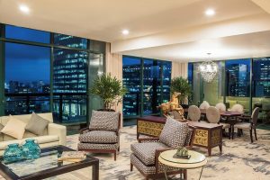 Gay-Friendly Sheraton Mexico City Maria Isabel Hotel suite at night. City views, stylish furniture, and a welcoming atmosphere.