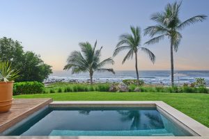 Gay-friendly hotel The St. Regis Punta Mita Resort view. Pool, palm trees, and ocean view. Luxury travel for gay men.