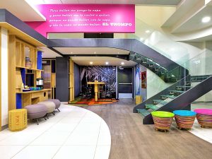 Ibis Styles Mexico Reforma's gay-friendly hotel lobby. Modern design with colorful accents, stairs, and seating areas. A welcoming space for gay travelers.