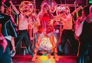 Gay Mexico City travel: Drag queen performs onstage with dancers at a nightclub. Nightlife scene in Zona Rosa, a gay-friendly area.