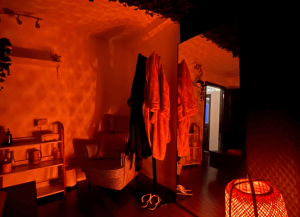 Interior of a spa in Dublin, Ireland. Focus on robes, chair, mirror, and warm lighting. Gay massage travel destination.