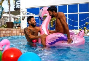 Two men on a flamingo float in a pool at La Iguana Vallarta, an LGBT adults-only hotel in Puerto Vallarta's Romantic Zone.