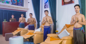 Paradise Massage Phnom Penh: Staff greets guests at a gay-friendly spa. Men in sarongs stand in front of massage chairs.