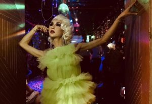 Drag queen at Reddog Bar. Performer in a green dress with disco ball. Gay travel nightlife. Reddog-Bar.jpg.