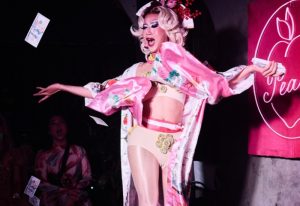Hanoi gay nightlife: Drag queen in kimono throwing money at a show in Savage club. Gay travel advice for Vietnam, Hanoi.