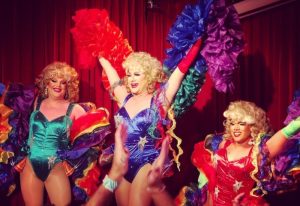 Drag queens perform at Stonewall Hotel, Sydney. Gay travel advice: experience Sydney's vibrant drag scene. Rainbow costumes, stage, fun.