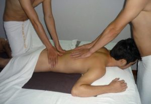 Hanoi Male Massage: Man receiving a four-hand massage in Hanoi. Gay travel advice for relaxation and wellness.