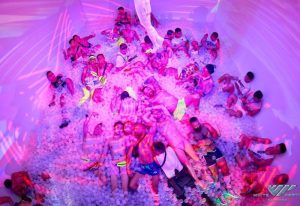 Gay men at White Party Bangkok, enjoying a ball pit. Travel advice for gay tourists. Nightlife, fun, and shirtless men in swimwear.