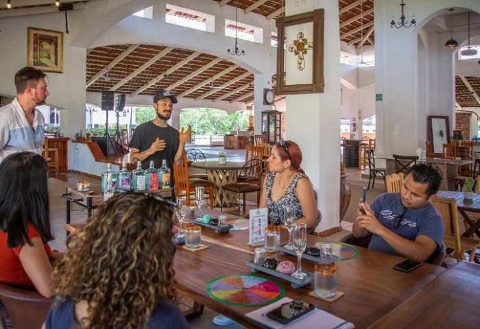 Gay Puerto Vallarta: Tequila & chocolate experience at a finca. People at a table, tasting. Gay travel advice, tours, and experiences.
