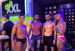 Shirtless men at Club XXL, a Sitges gay club. The club is a dance and shower bar, popular for gay nightlife in Sitges, Spain.