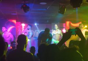CENTURYON Gay Club in Torremolinos: Male dancers perform on stage for a crowd in the popular gay nightlife spot. Torremolinos gay travel.