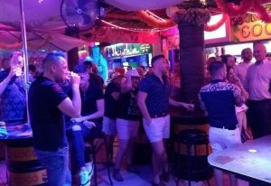 Coco Loco Gay Bar in Gran Canaria. Interior view of a lively gay bar with men socializing, drinking, and enjoying the atmosphere.
