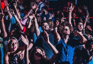 City Hall Disco: Barcelona gay club scene. Crowd of diverse people dancing, hands raised, enjoying the music and nightlife.
