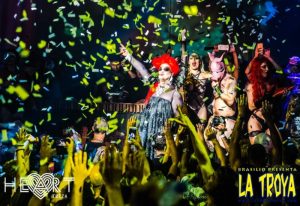La Troya gay club in Ibiza's Heart nightclub. Drag queens and performers entertain a crowd under falling confetti. Gay travel.