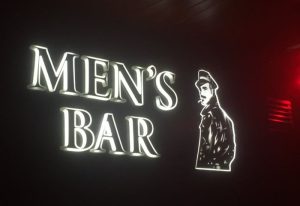 Men's Bar sign in Torremolinos, a gay cruise club. Neon sign with a leather man icon. Gay travel destination.