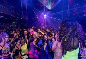 Packed Prima s-Bar gay bar in Madrid with drag queens, laser lights, and disco ball. Gay nightlife travel advice.