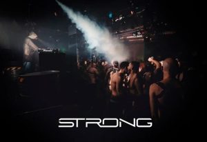 STRONG Gay Club in Madrid. Gay cruise club scene with shirtless men dancing. DJ playing music. Gay nightlife, travel advice.