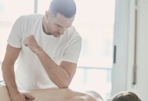 Barcelona male massage: Man giving under-pressure massage. Gay massage in Barcelona for men's wellness and relaxation. Bodywork therapy.