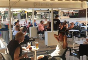 Vanilla Cafe Gay Bar in Torremolinos: Outdoor seating area with men enjoying drinks. Gay travel destination in Spain. Summer vibes.