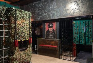 Interior of XXL Torremolinos Gay Cruise Club. Cage, portrait of a man in leather, and dark, industrial decor. Gay travel in Spain.