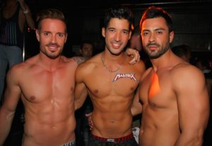 Gran Canaria gay clubs: Three shirtless men pose at Mantrix gay club. Gay nightlife in Gran Canaria, a popular gay travel destination.