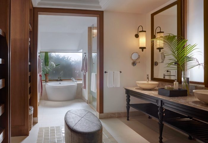 Santiburi Koh Samui deluxe beachfront villa bathroom. Bathtub, double vanity with vessel sinks, and tropical decor. Gay travel luxury resort.