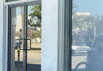 The Clubhouse II entrance. Glass doors with Members Required sign. Gay travel tip: Exclusive gay club, private club.