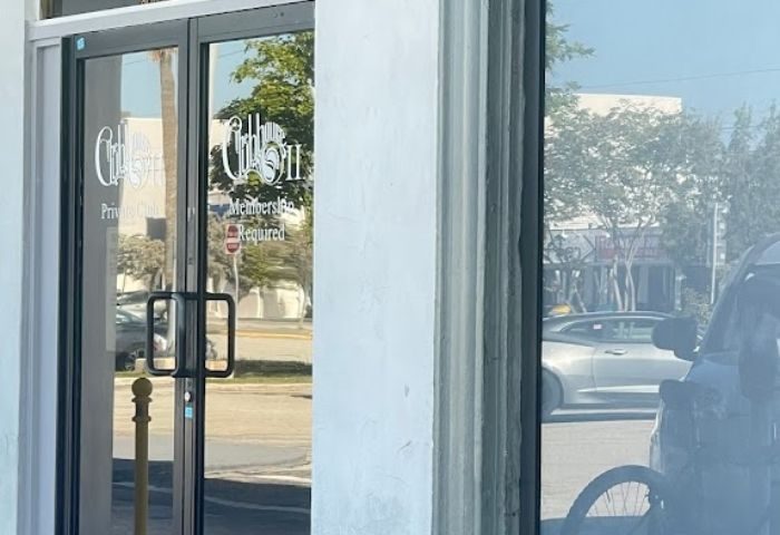 The Clubhouse II entrance. Glass doors with Members Required sign. Gay travel tip: Exclusive gay club, private club.
