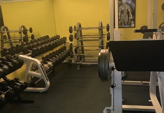 Club Aqua gym: Dumbbells, barbells, and weight machines. A fitness space for gay men's travel, promoting health and wellness on vacation.