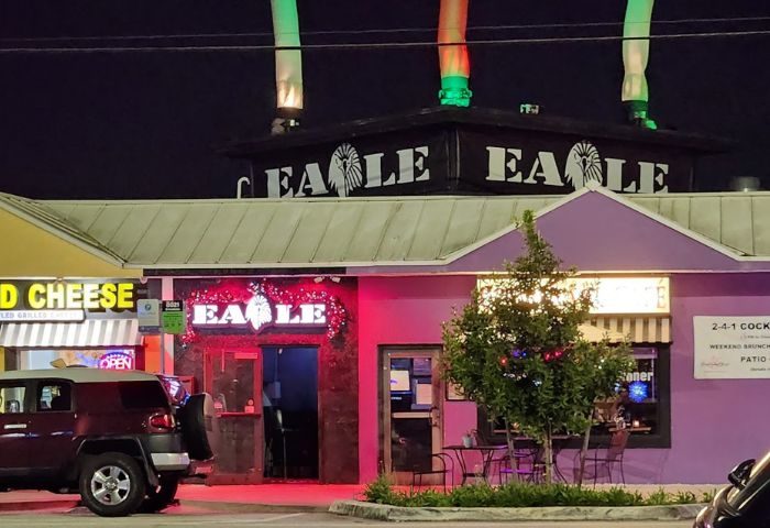 The Eagle Wilton Manors gay bar at night. Exterior view of the gay bar with colorful lights and signage. Gay travel destination.