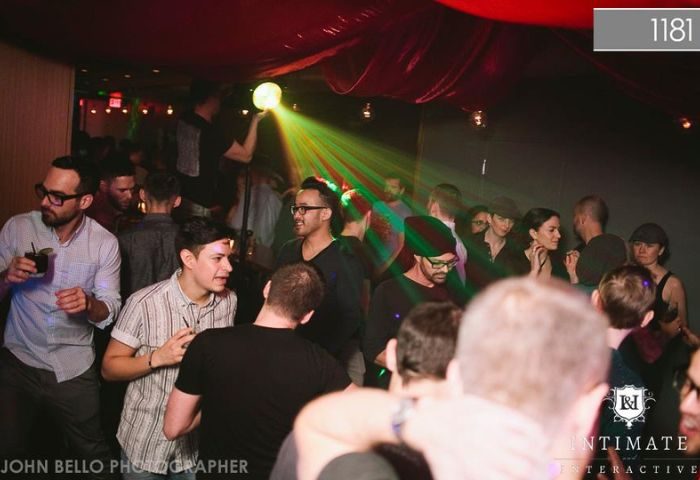 Vancouver's 1181 Lounge: Gay men enjoy a night out in the vibrant, dimly lit club. Green laser lights add to the atmosphere. #gaytravel