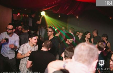 Vancouver's 1181 Lounge: Gay men enjoy a night out in the vibrant, dimly lit club. Green laser lights add to the atmosphere. #gaytravel