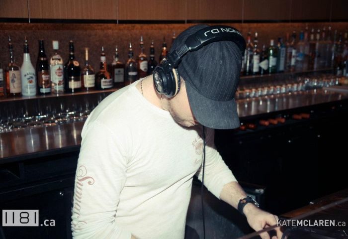 DJ at 1181 Lounge in Vancouver. A gay bar with a DJ playing music. Vancouver's nightlife is vibrant and inclusive. Gay travel advice.